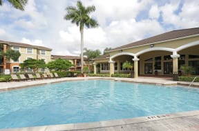 Pool area with large sundeck , lounge chairs and lanai area for relaxing