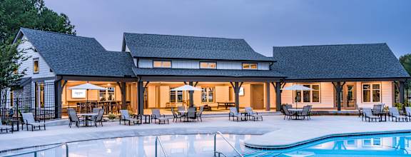 A large house with a pool in front.