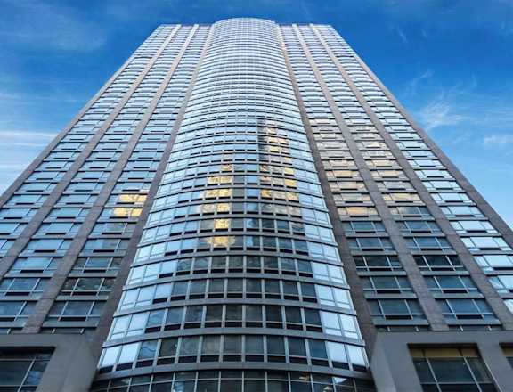 A tall building with many windows is shown in the image.