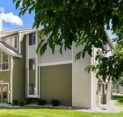 A modern house with a green lawn in front.