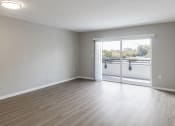 Thumbnail 6 of 18 - a bedroom with a sliding glass door and hardwood floors at Lakeside @ Biscayne Gardens,North Miami, FL,33181