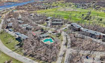 an aerial view of a neighborhood with trees and buildings and a river