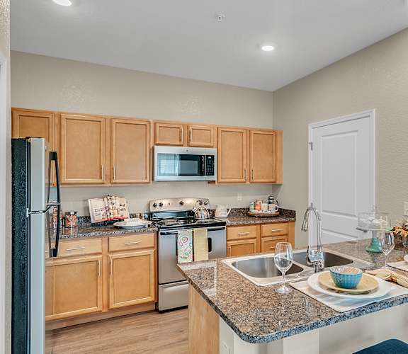 a kitchen with granite countertops and stainless steel appliances