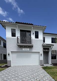 A two-story house with a balcony and a garage.