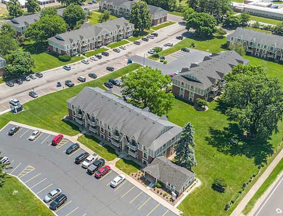 an aerial view of a neighborhood of houses with cars parked on the street at Briarwood Apartments in Benton Harbor, MI