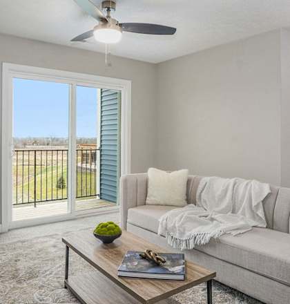a living room with a couch and a chair at Meadowbrooke Apartment Homes, Grand Rapids, MI