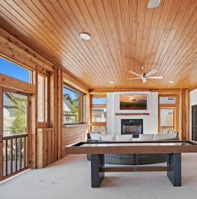 a living room with a large table and a fireplace
