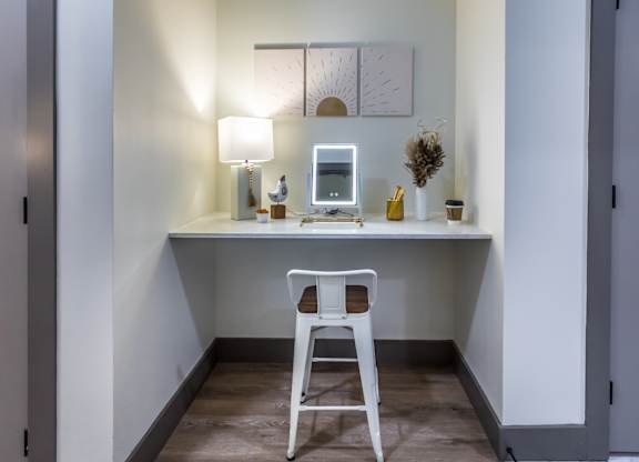 a small desk with a chair and a computer