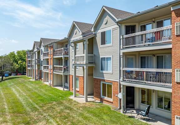 Apartment building with a green lawn in front.