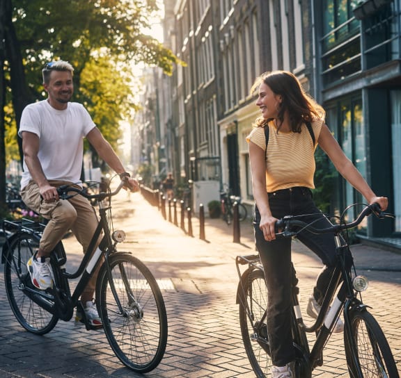 a man and a woman riding bikes down a city street at Boardwalk at Research Park, Alabama, 35811