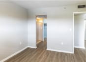Thumbnail 12 of 18 - a bedroom with hardwood floors and white walls at Lakeside @ Biscayne Gardens,North Miami, FL,33181