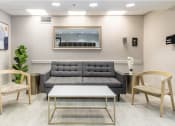 Thumbnail 14 of 18 - a living room with a gray couch and two chairs at Lakeside @ Biscayne Gardens,North Miami, FL,33181