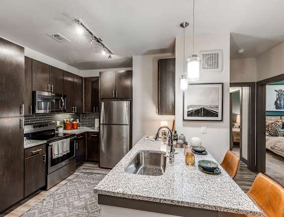a kitchen with stainless steel appliances and granite counter tops