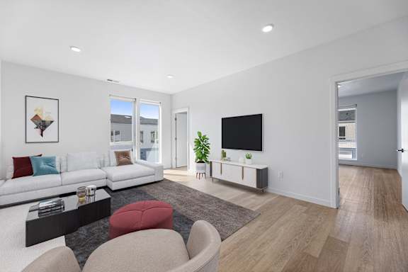 a living room with a white couch and a tv