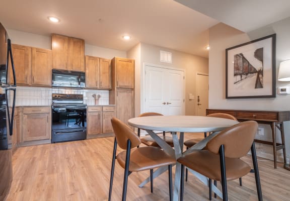 a kitchen and dining room with a table and chairs