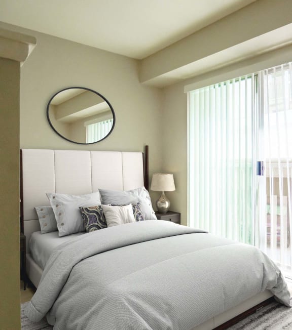 a bedroom with a bed and a sliding glass door