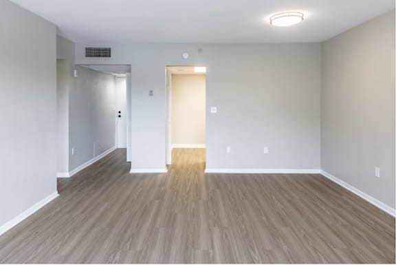 an empty living room with wood floors and white walls at Lakeside @ Biscayne Gardens,North Miami, FL,33181