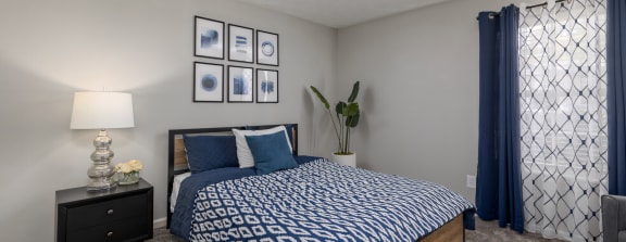 a bedroom with a bed and a window with a blue curtain at Glen Hollow, Georgia, 30034