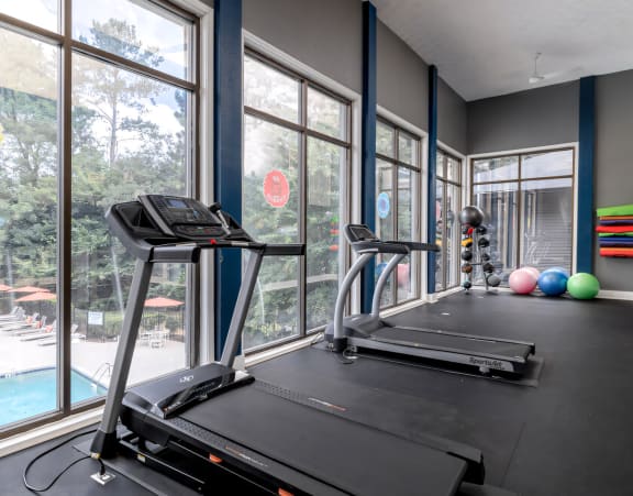 the gym with plenty of windows and cardio equipment at 1861 muleshoe road at Glen Hollow, Decatur, 30034