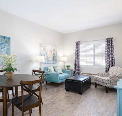 A dining room with a table set for four.