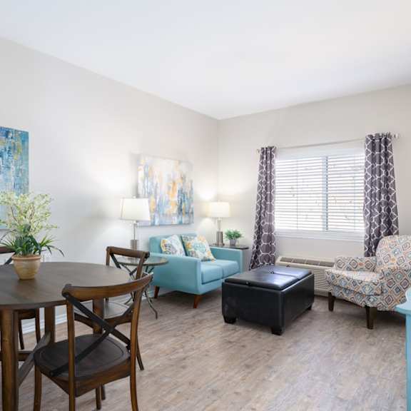 A dining room with a table set for four.