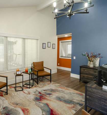 A living room with a brown chair and a small table.