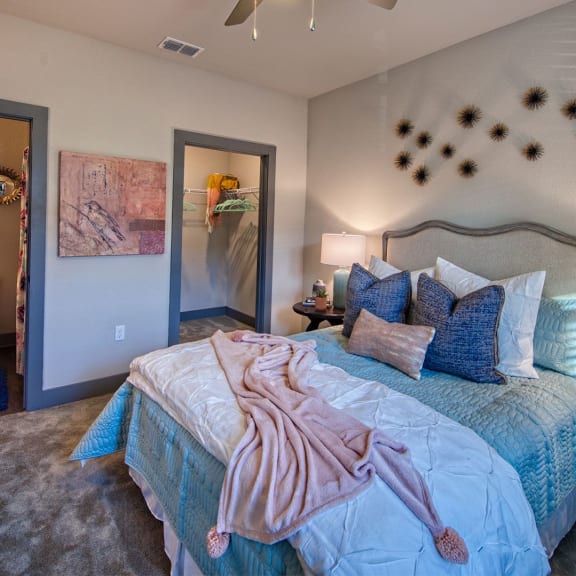 a bedroom with a bed and a ceiling fan