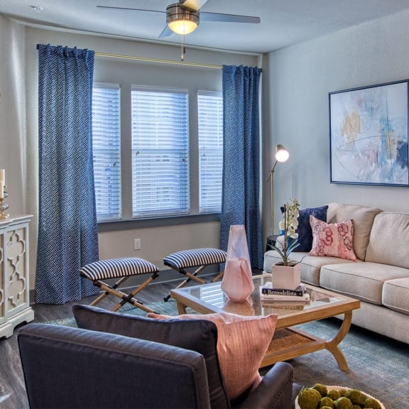 a living room filled with furniture and a large window