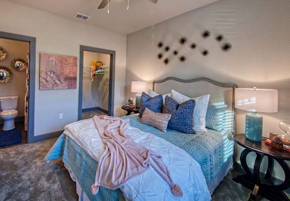 a bedroom with a bed and a ceiling fan