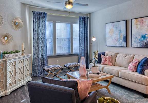 a living room filled with furniture and a large window