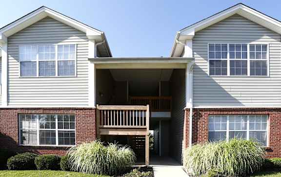 A two-story house with a front porch and a garage.