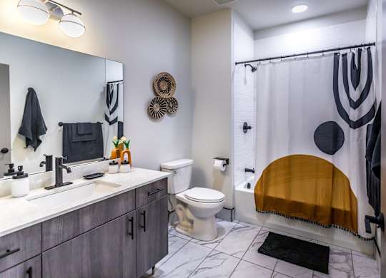 a bathroom with a shower and a sink and a toilet