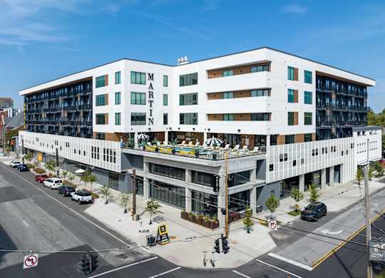 an aerial view of a large white building on a city street