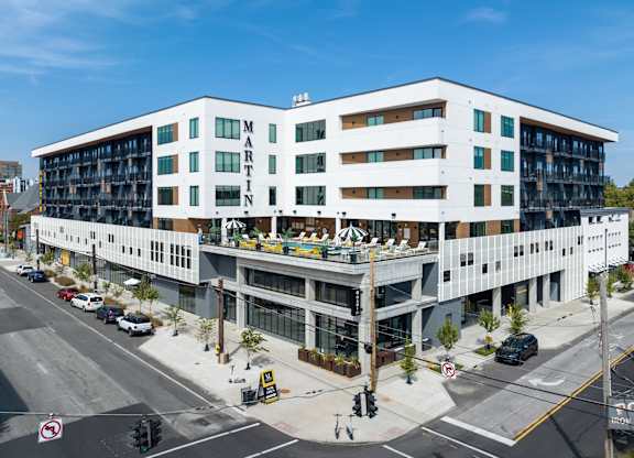 an aerial view of a large white building on a city street