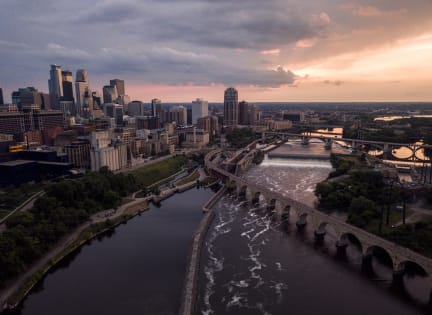 an aerial view of the city of minneapolis at sunset