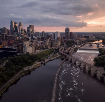 an aerial view of the city of minneapolis at sunset