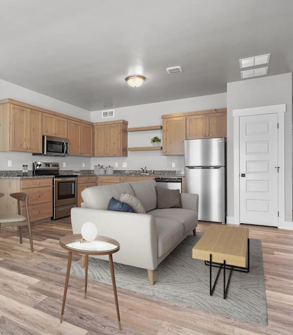 A modern kitchen with a white couch and wooden floors.