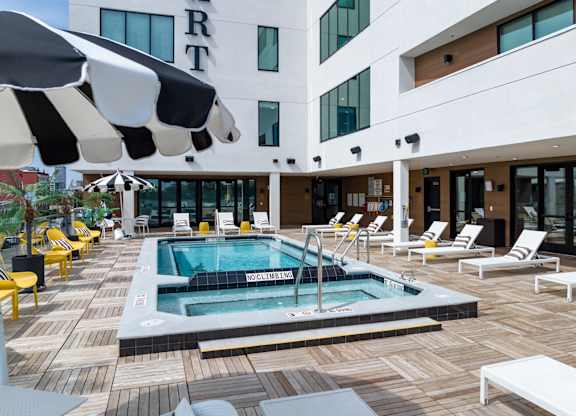 Studios In Butchertown, KY - Martin On Main - Pool With Jacuzzi, Chairs, Lounge Chairs, And Umbrellas