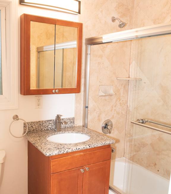 A bathroom with a sink and mirror.