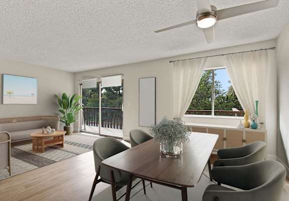 a living room and dining room with a table and chairs