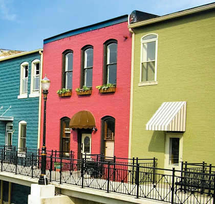 a row of colorful houses next to a river