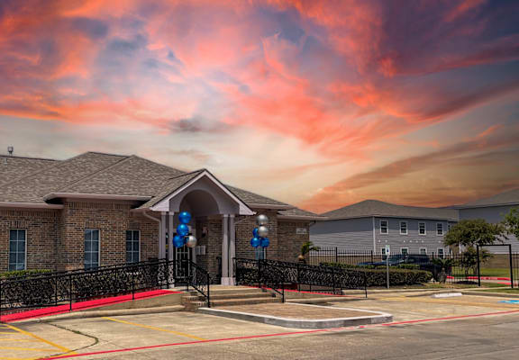 a house with a red and orange sky in the background
