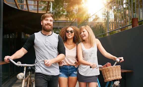 a group of people riding bikes on a city street