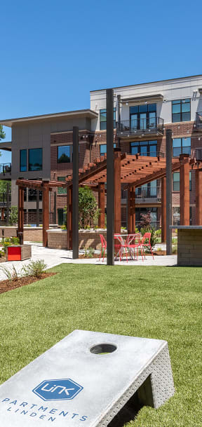 a park with a stone bench in front of a building  at Link Apartments® Canvas, Atlanta