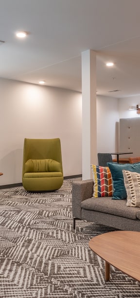 a living room with couches and chairs and a table  at Link Apartments® Canvas, Atlanta