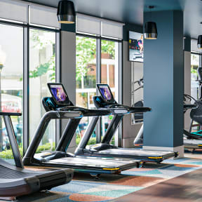 Spacious Fitness Facility with Cardio Equipment with Televisions and Mirror at Link Apartments 4th Street in Winston-Salem, North Carolina, 27101