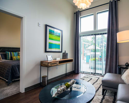 a living area with a couch coffee table and sliding glass door to a balcony at Link Apartments® Canvas, Atlanta, GA, 30312