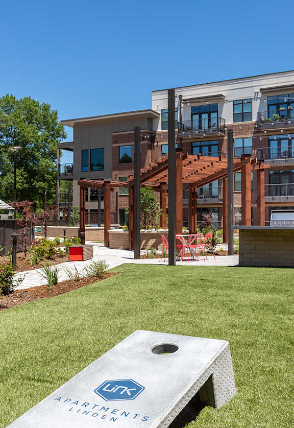 a grassy area with a stone bench in front of a building  at Link Apartments® Canvas, Atlanta