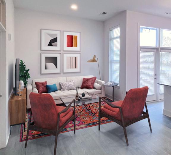 Apartment Living Room and Kitchen Area with a White Couch, Colorful Throw Pillows at Link Apartments 4th Street in Winston-Salem, NC