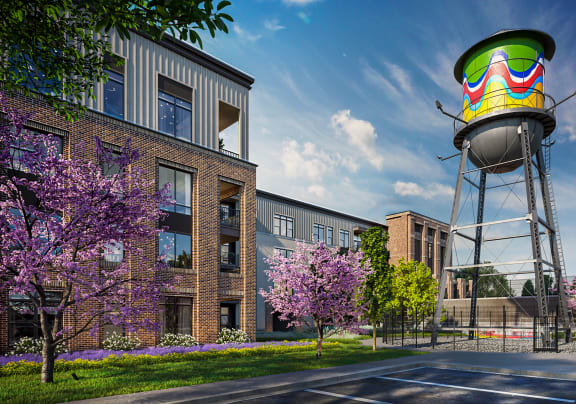 a water tower sits in front of an apartment complex